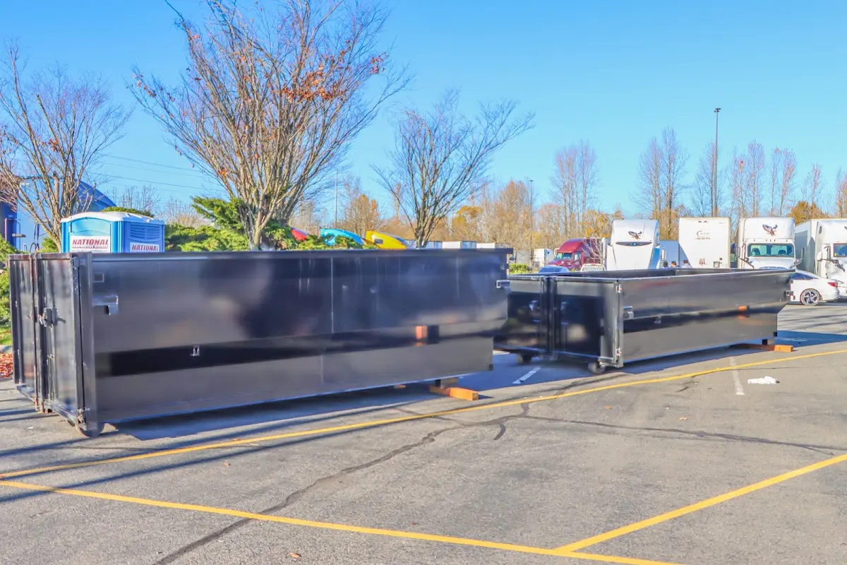 Professional dumpster rental service with roll-off container on residential driveway in Foley